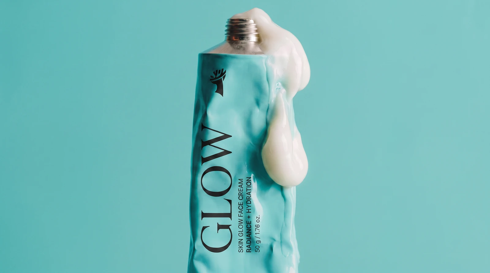 Foret Glow face cream tube squeezed against a teal ground