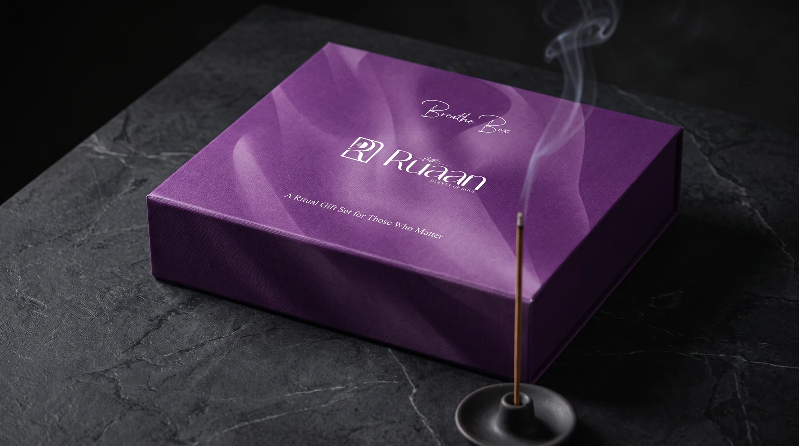 Purple Breathe Box on slate with a lit incense stick smoking