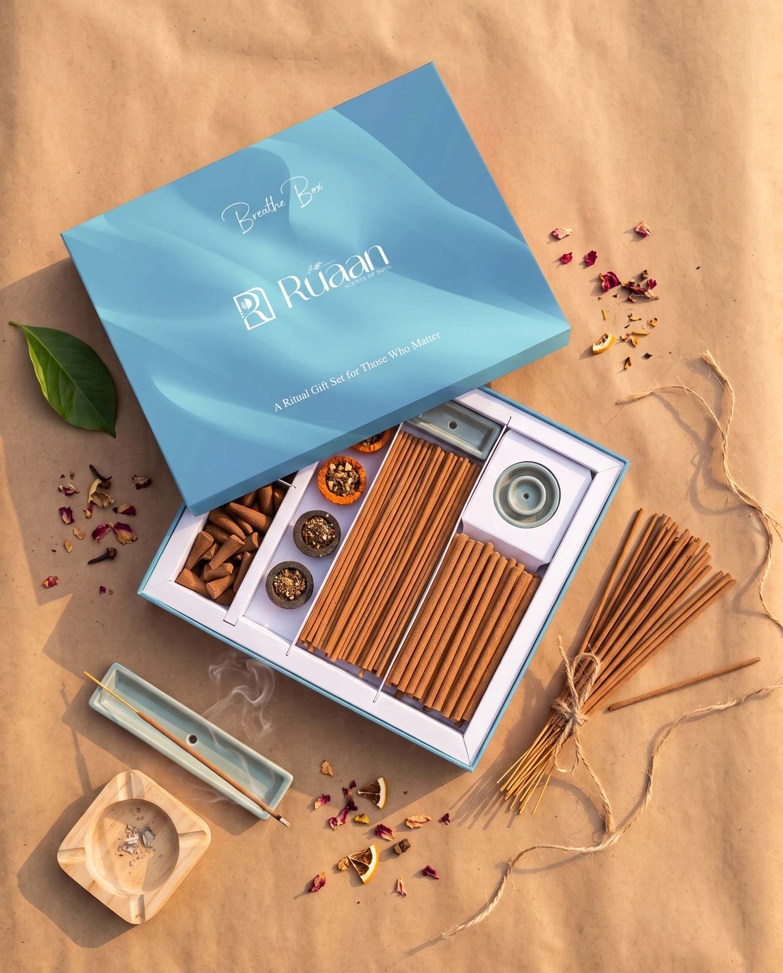 Sky blue Breathe Box open on kraft paper with rose petals