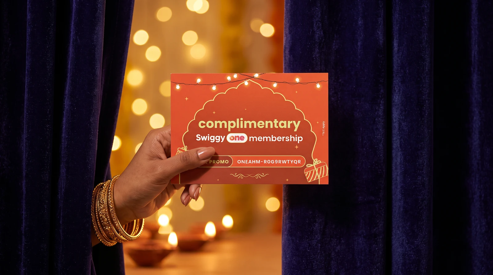 Hand holding the voucher through a velvet curtain under string lights