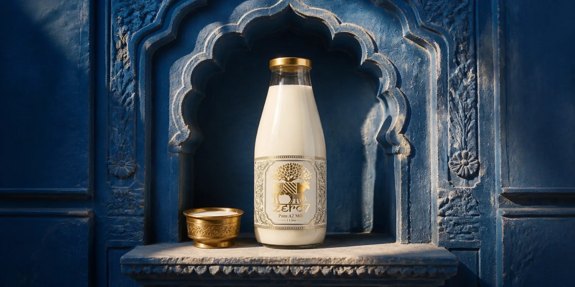 zero7 bottle standing in a carved indigo niche beside a brass cup of milk